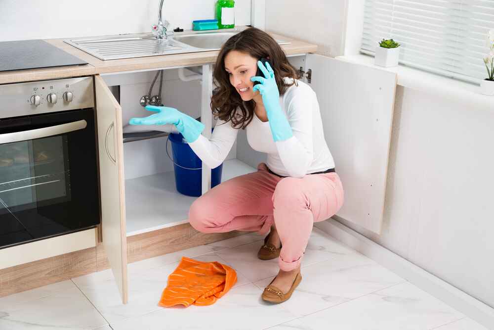 Homeowner in Front of a Clogged Drain