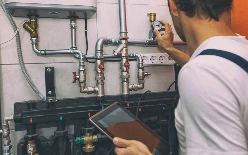 Technician Inspecting Pipe Systems