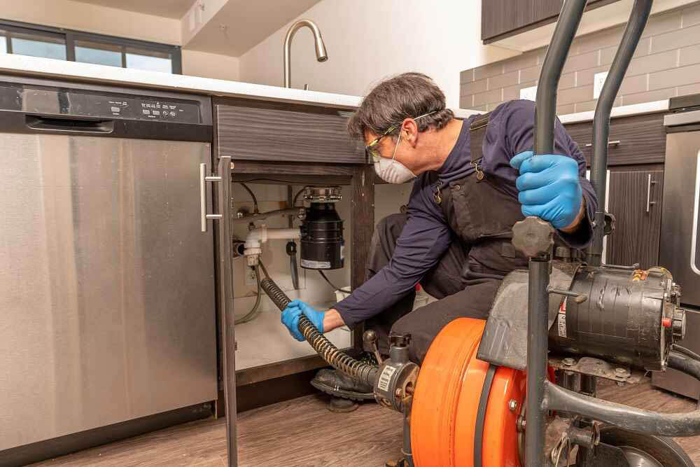 plumber cleaning drain