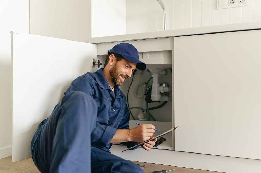 plumber inspecting drain pipe